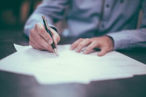 An insurance agent signing an SR22 document.