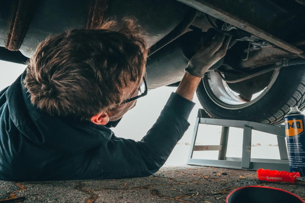 Man inspecting and working on car